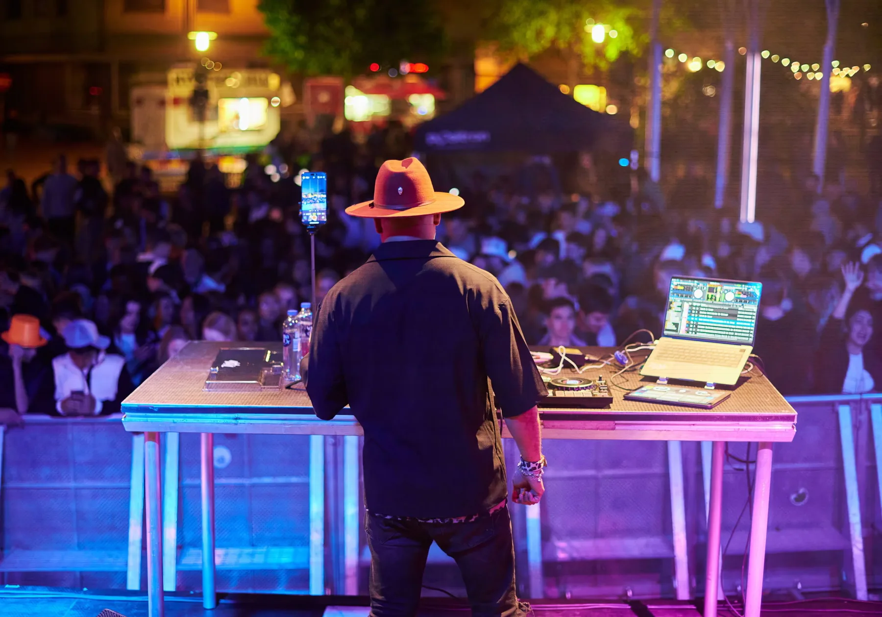DJ Ale behind the decks in front of a festival audience